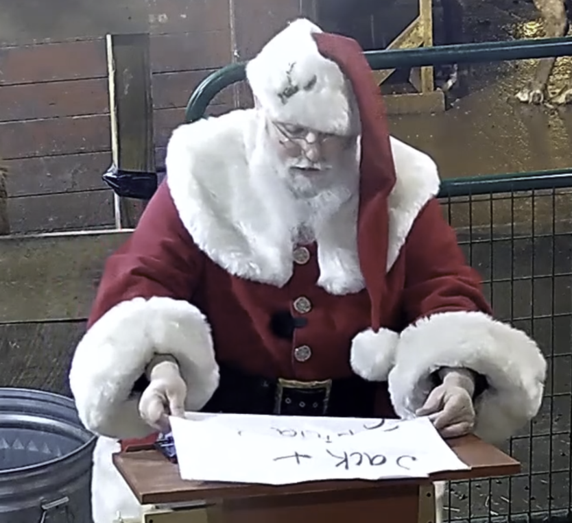 Santa standing reading from Nice List scroll